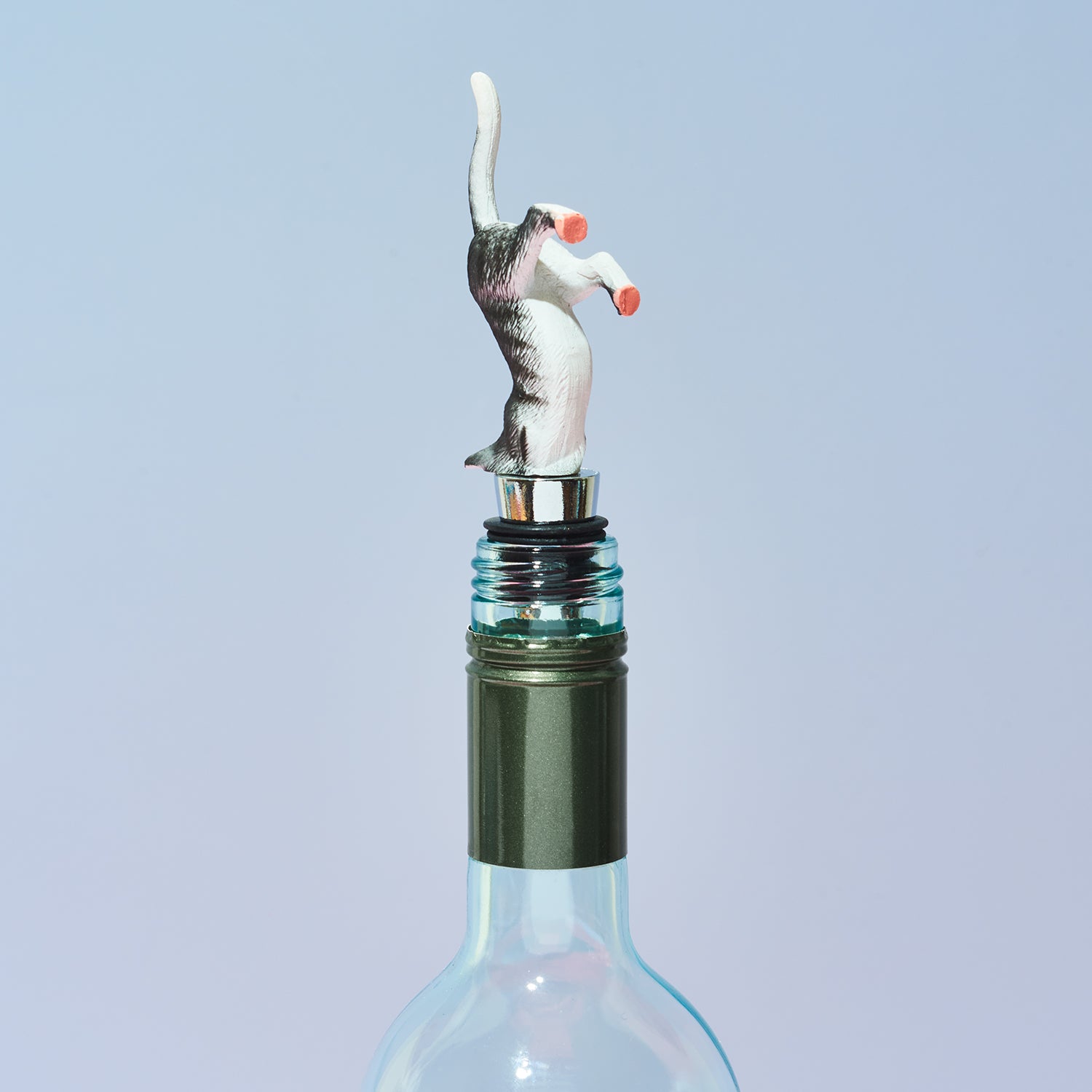 Wine bottle stopper shaped like a cat on a light blue background