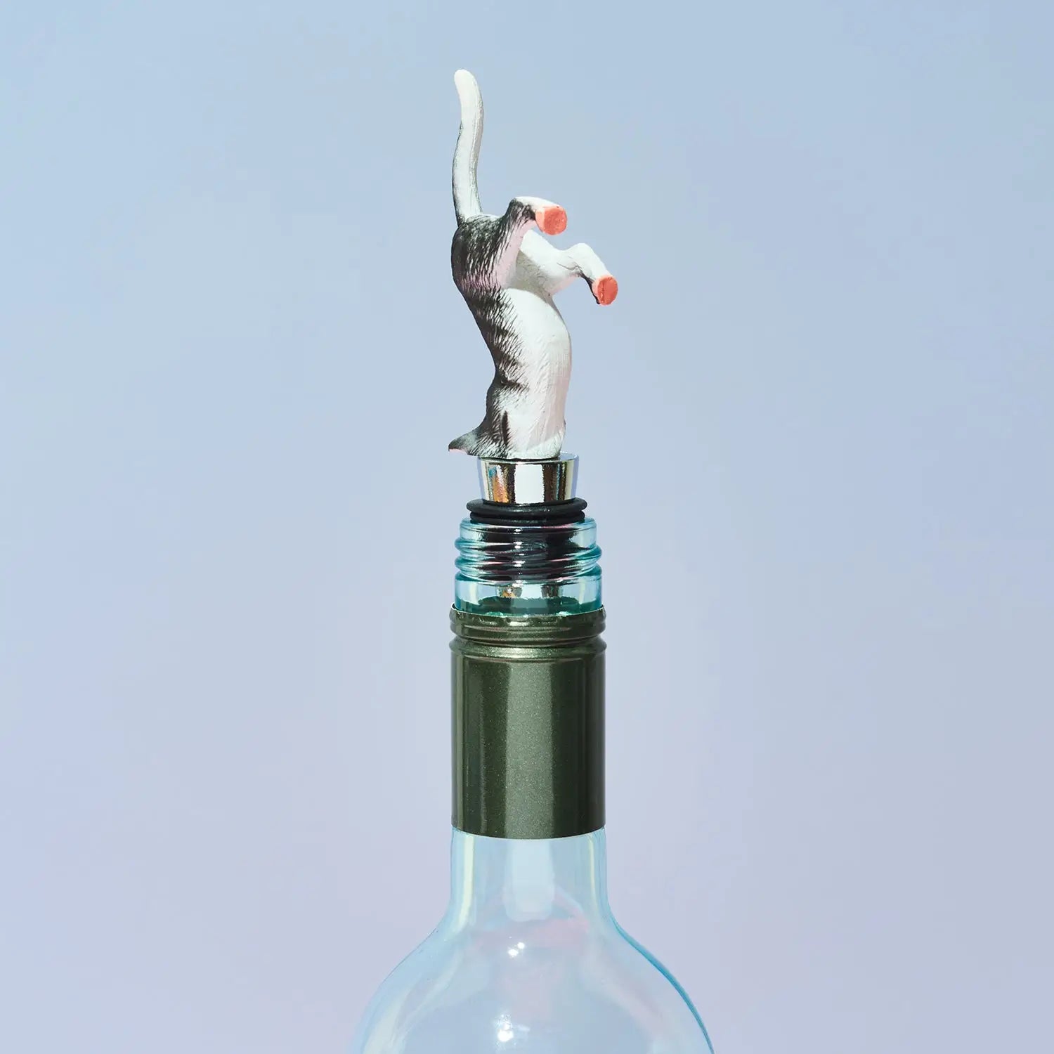 Wine bottle stopper shaped like a cat on a light blue background