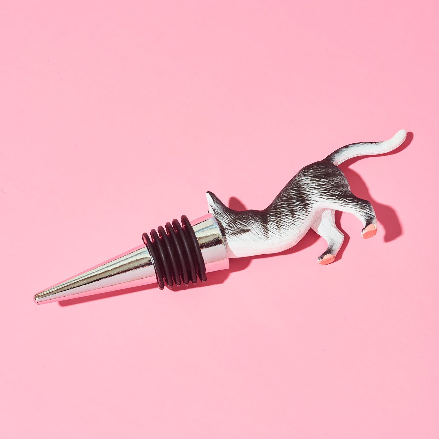 Cat-shaped bottle stopper on a pink background