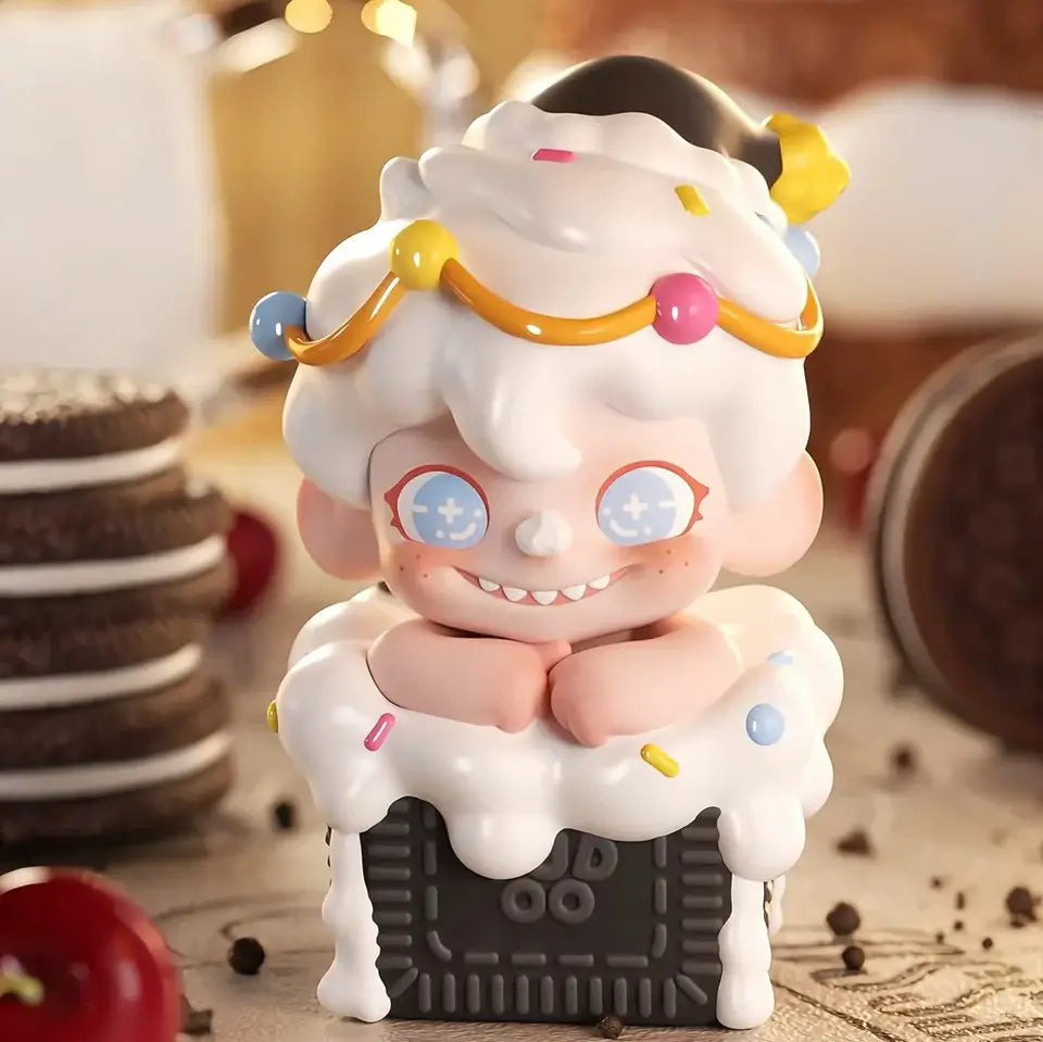 Cute character figurine with whipped cream and colorful decorations on a wooden surface with cookies in the background.