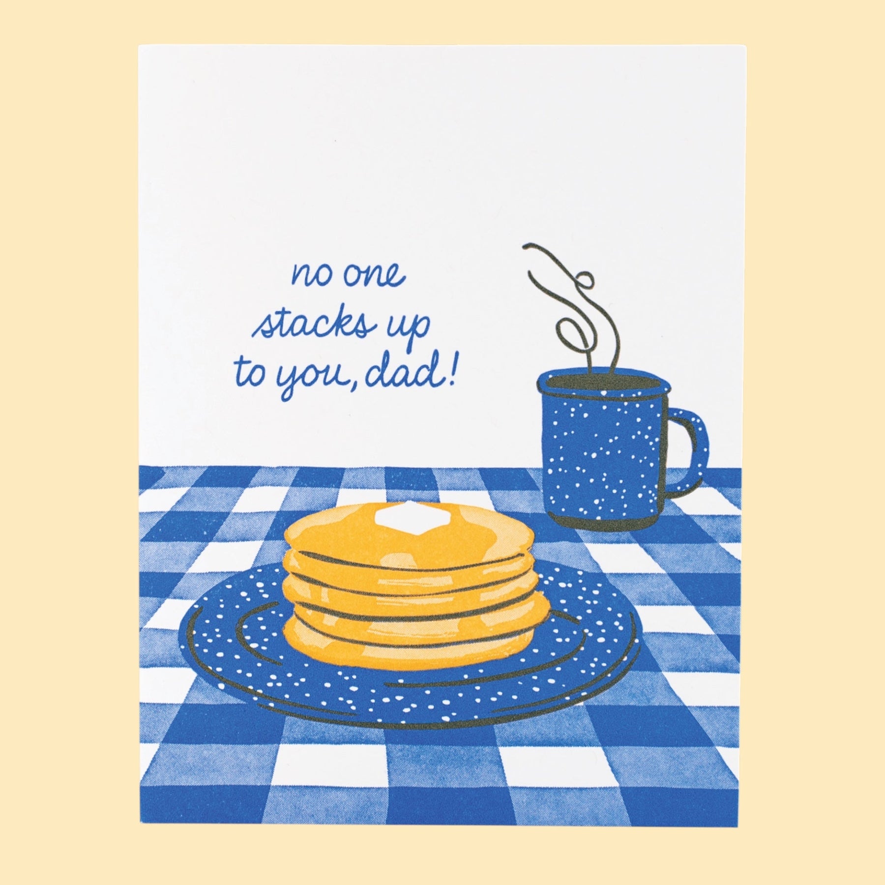 Illustration of pancakes and a coffee cup on a blue checkered tablecloth with text 'no one stacks up to you, dad!'