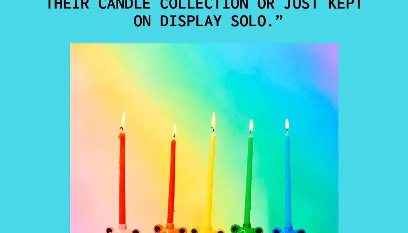 Five colorful dancing bear figures holding birthday candles arranged in a rainbow gradient line.