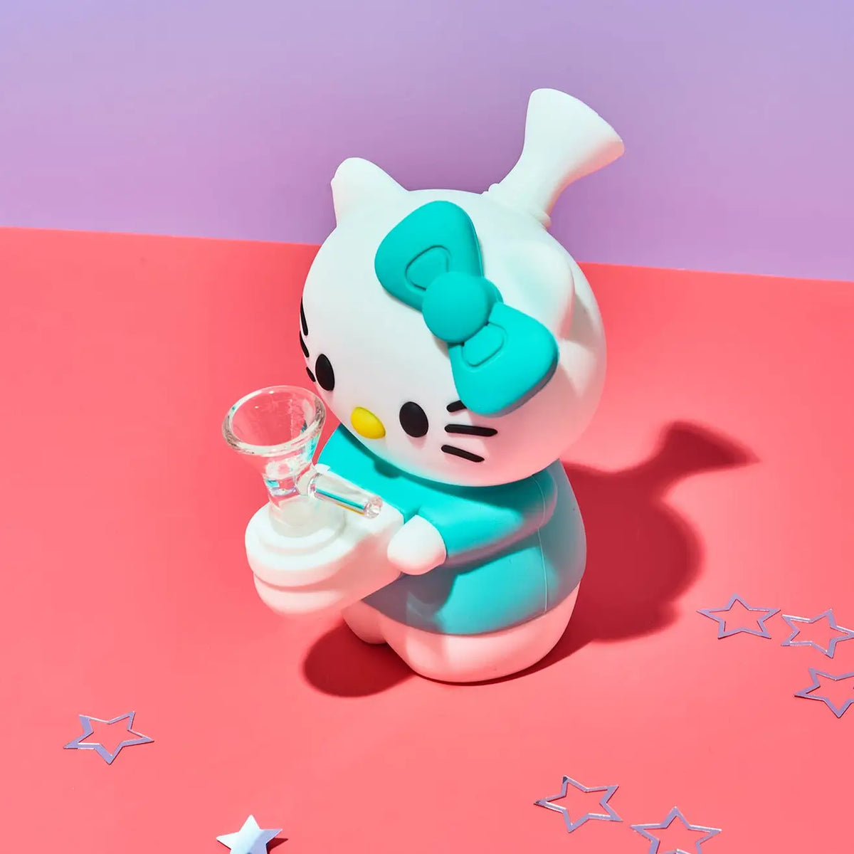 Friends NYC Match Green Hello Kitty Blind Box Bong surrounded by stars on a pink table