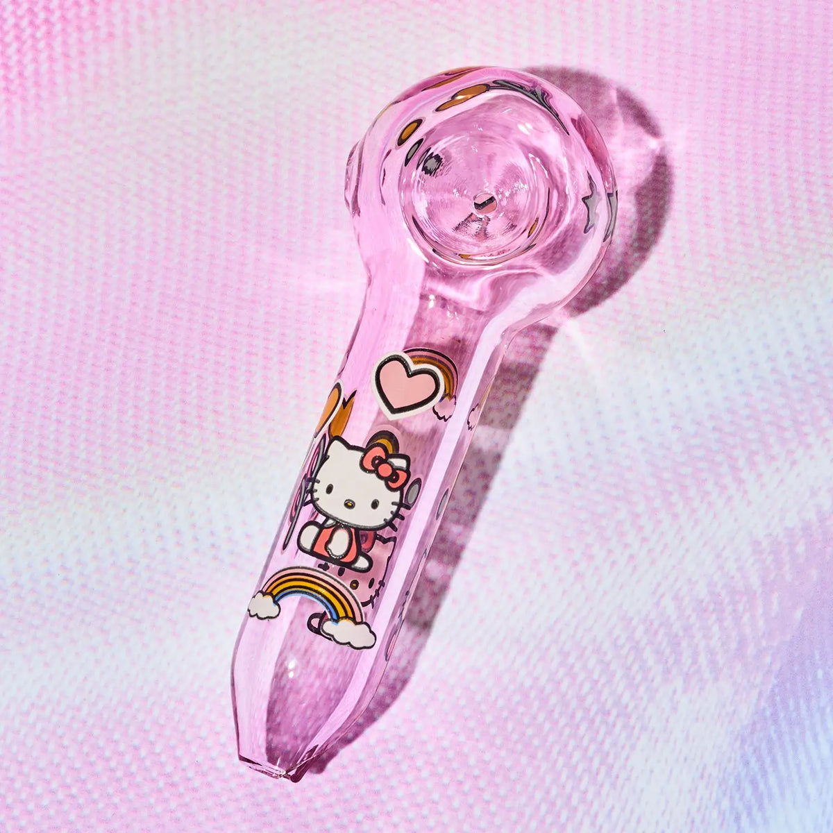A pink glass water pipe featuring a Hello Kitty cartoon design, shown on a textured pink background.