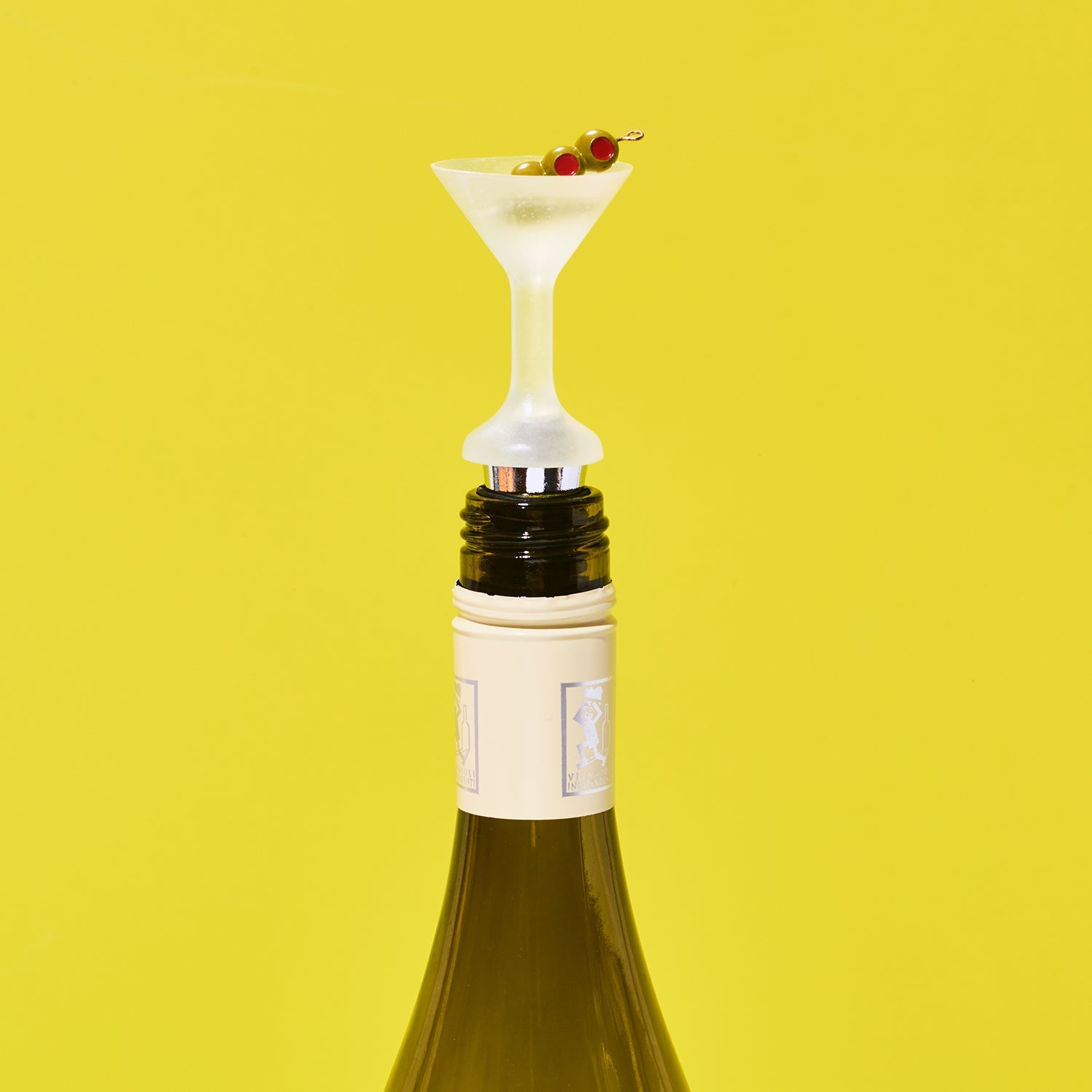 Wine bottle with a novelty bottle stopper shaped like a cocktail glass on a yellow background