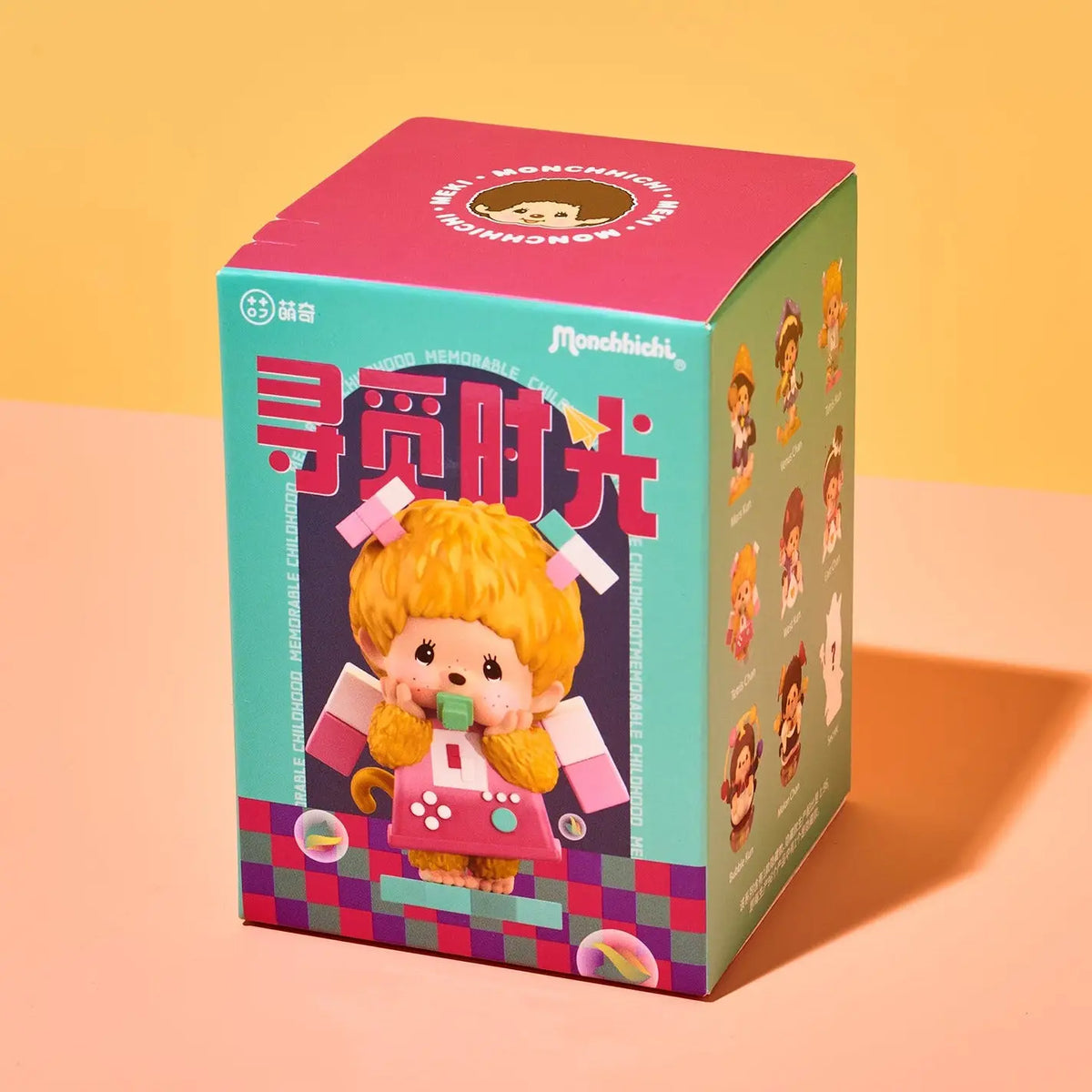 A collectible blind box for Monbello mini figures, featuring a colorful design with a pink top, teal side panels, and a cartoon character with yellow hair on the front, set against a warm yellow and peach background.