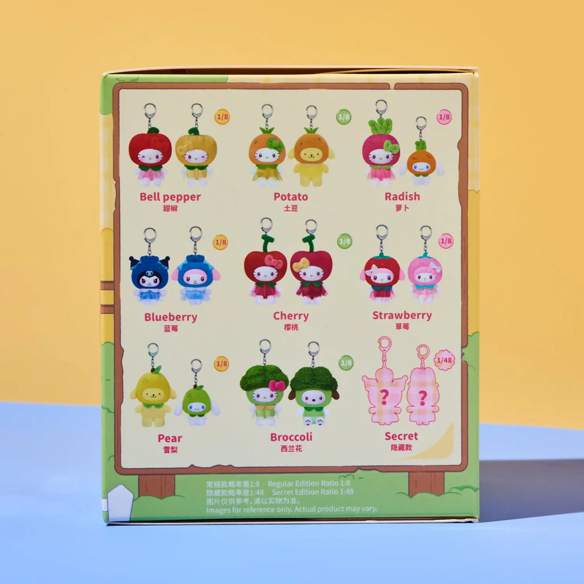 A collectible blind box featuring a grid of 15 cartoon character keychains (including Bell pepper, Potato, Radish, Blueberry, Cherry, Strawberry, Pear, Broccoli, and Secret) on the back of the packaging, set against a yellow and blue background.