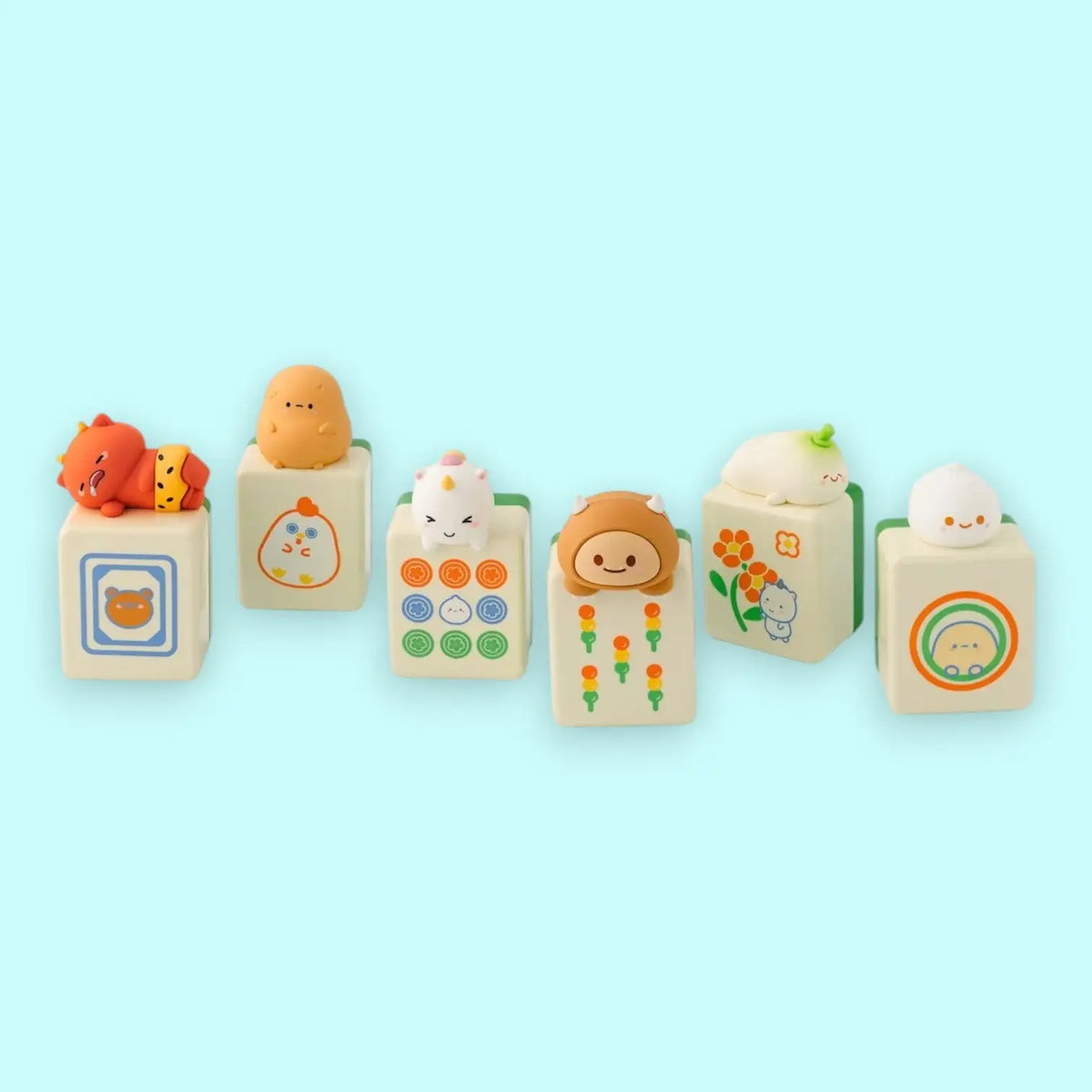 Set of cute characters on mahjong blocks with various designs on a light blue background