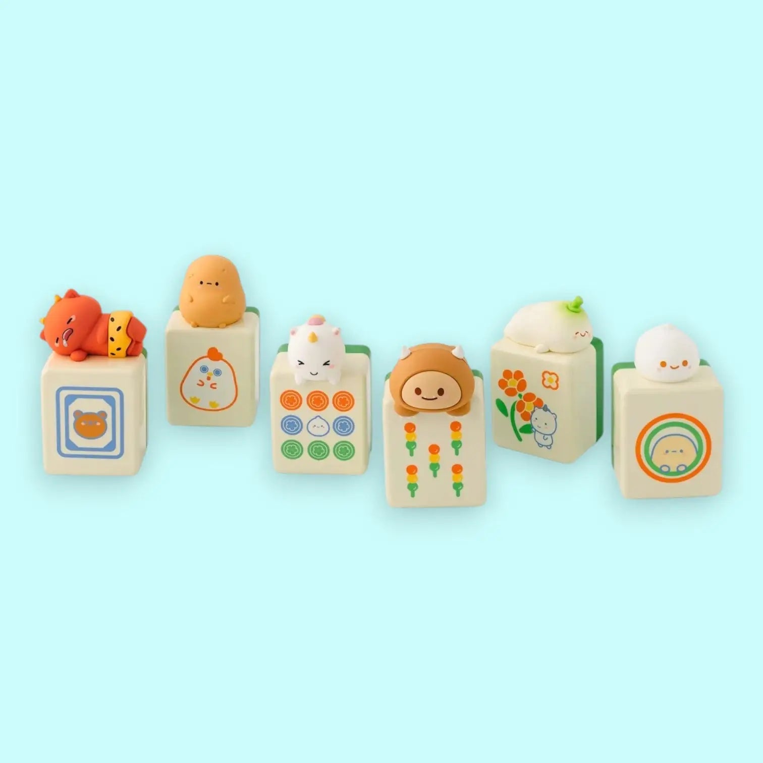 Set of cute characters on mahjong blocks with various designs on a light blue background