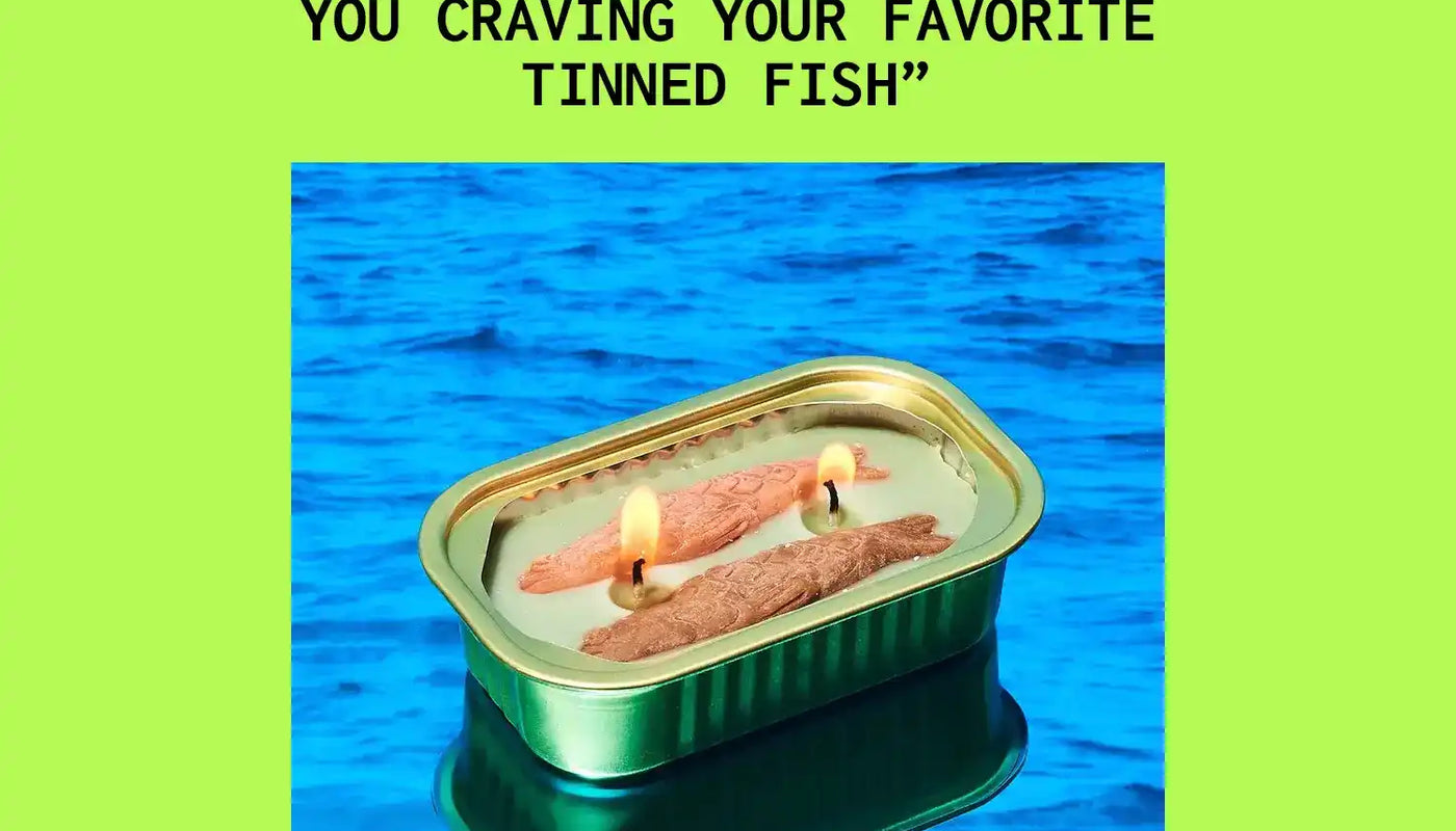 A tin can of fish photographed against a blue backdrop.