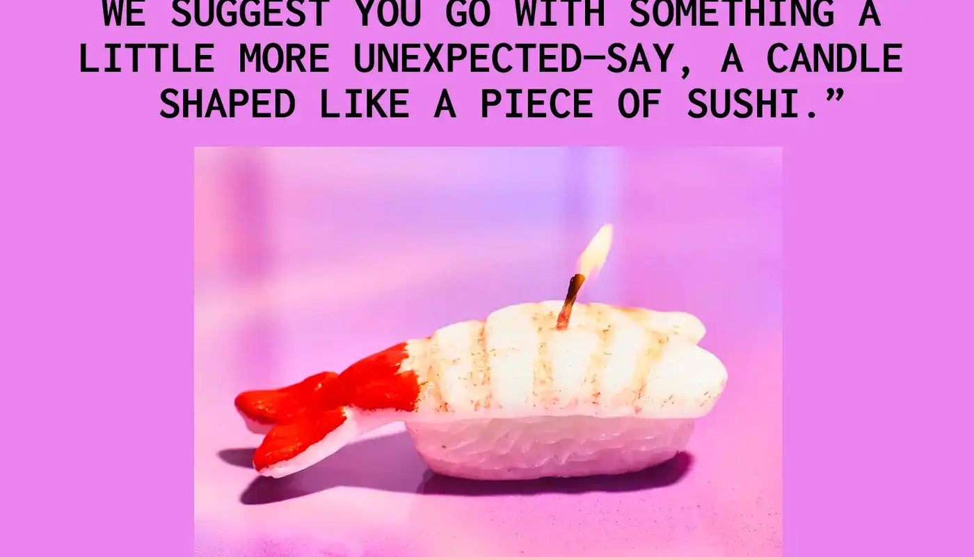 White candle shaped like a piece of nigiri sushi with a red accent.