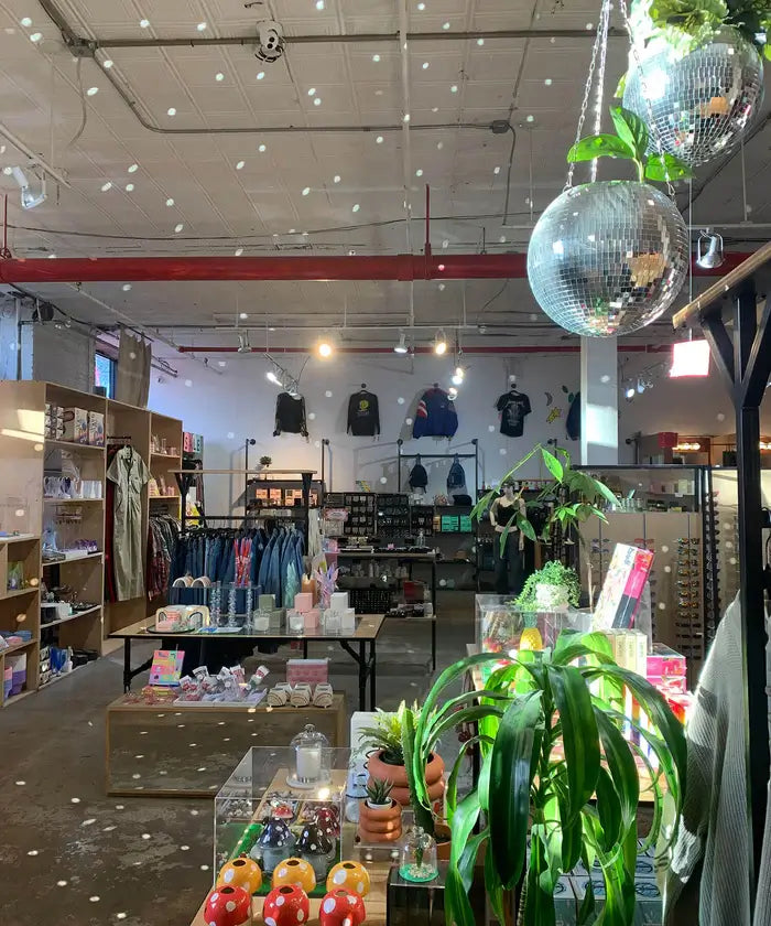 Aesthetic Friends NYC Brooklyn store moment with multiple hanging disco balls casts spots of light across store