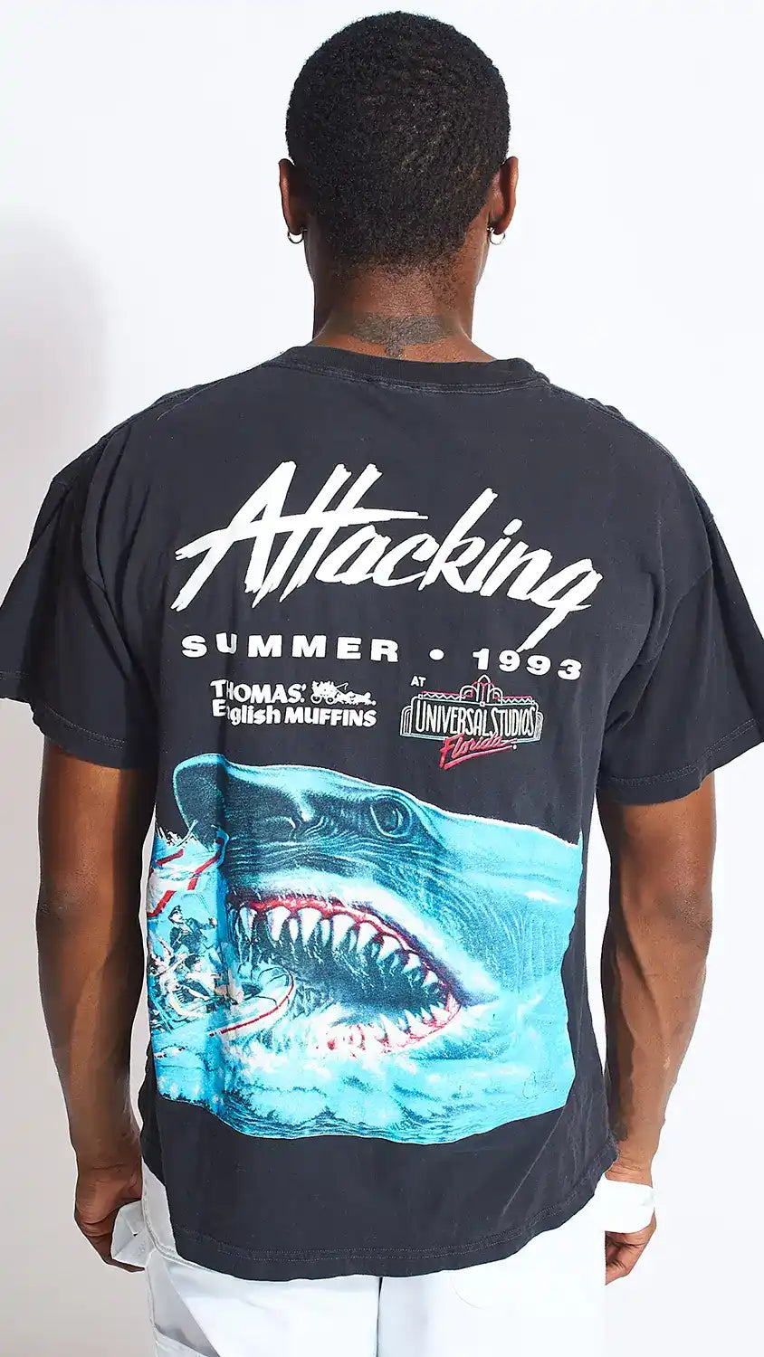 Black t-shirt with a shark graphic and ’Attacking’ text design on the back.