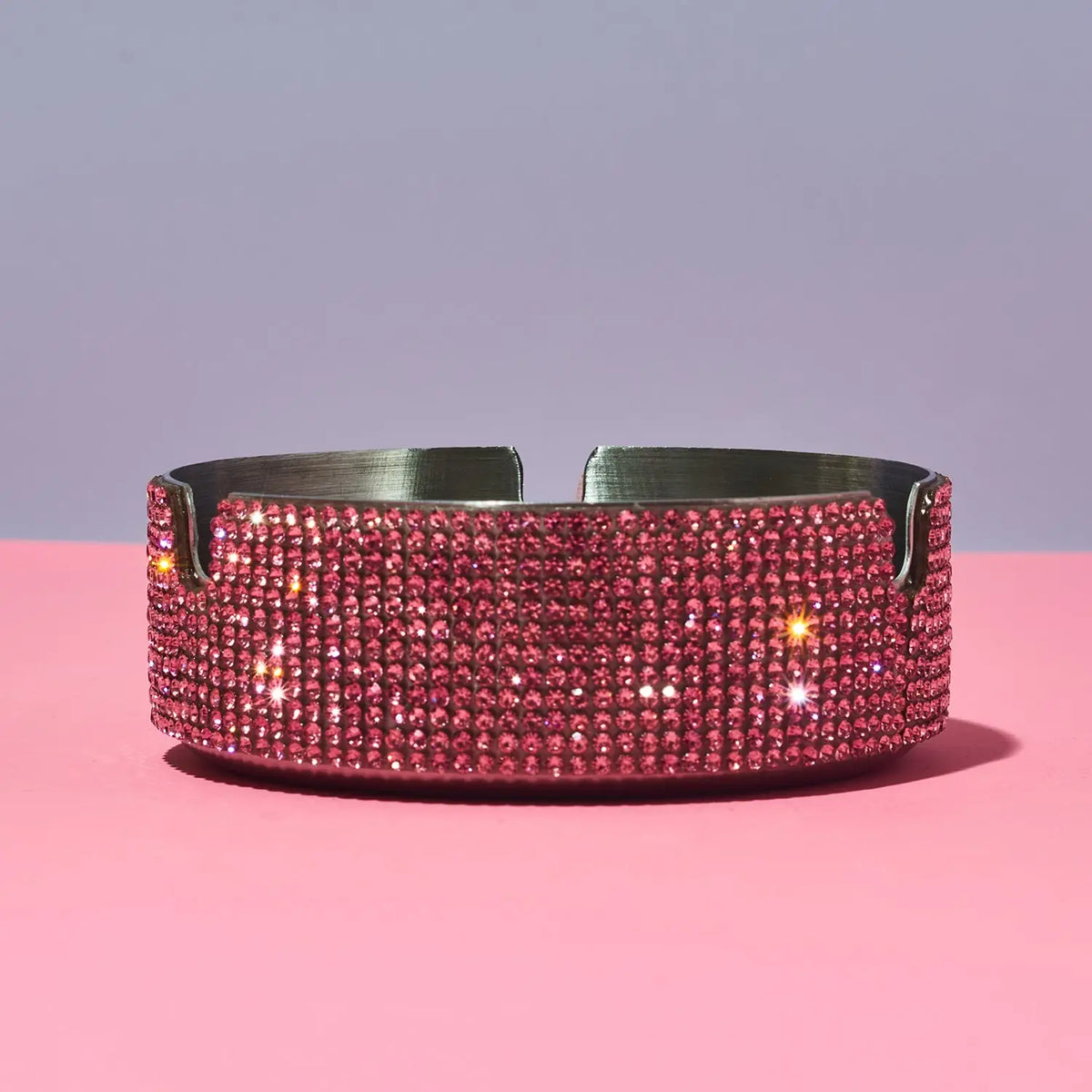 Pink rhinestone ashtray on a pink background