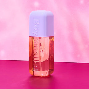 Perfume bottle with a light purple cap on a pink background