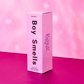 Pink 'Boy Smells' product packaging on a pink background