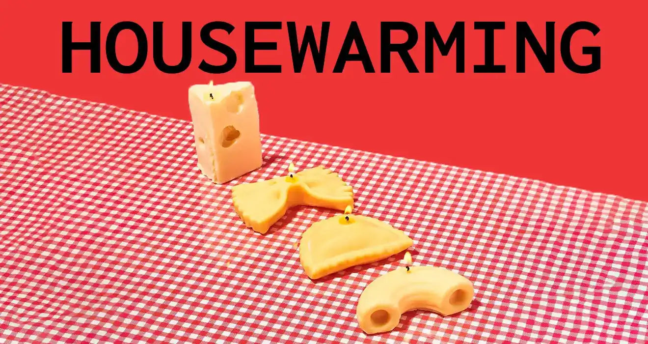 Cheese slices arranged diagonally on a red and white checkered tablecloth under text reading ’HOUSEWARMING’