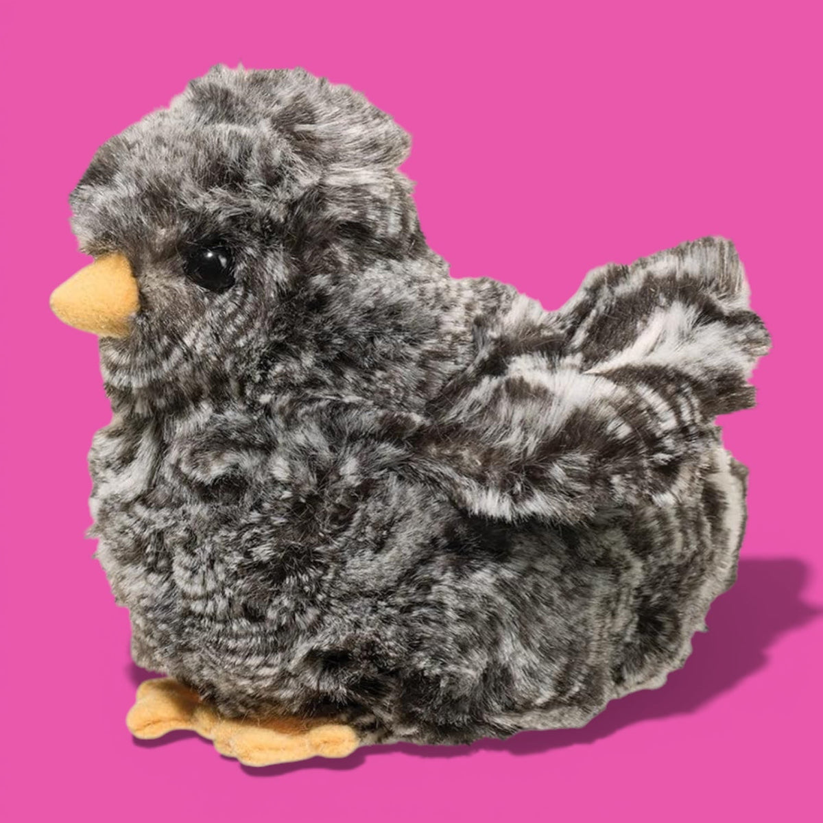 Plush baby owl toy on a pink background