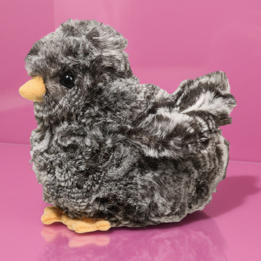 Plush baby owl toy on a pink background