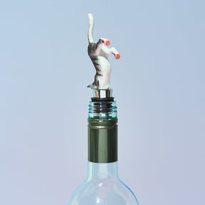 Wine bottle stopper shaped like a cat on a light blue background