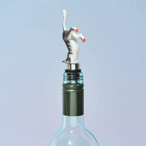 Wine bottle stopper shaped like a cat on a light blue background