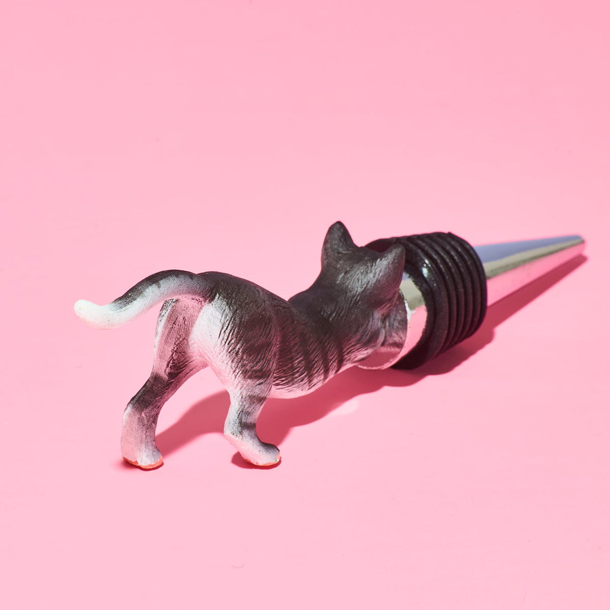 Cat-shaped bottle stopper on a pink background