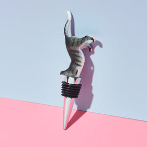 Cat-shaped bottle stopper on a pink and blue background