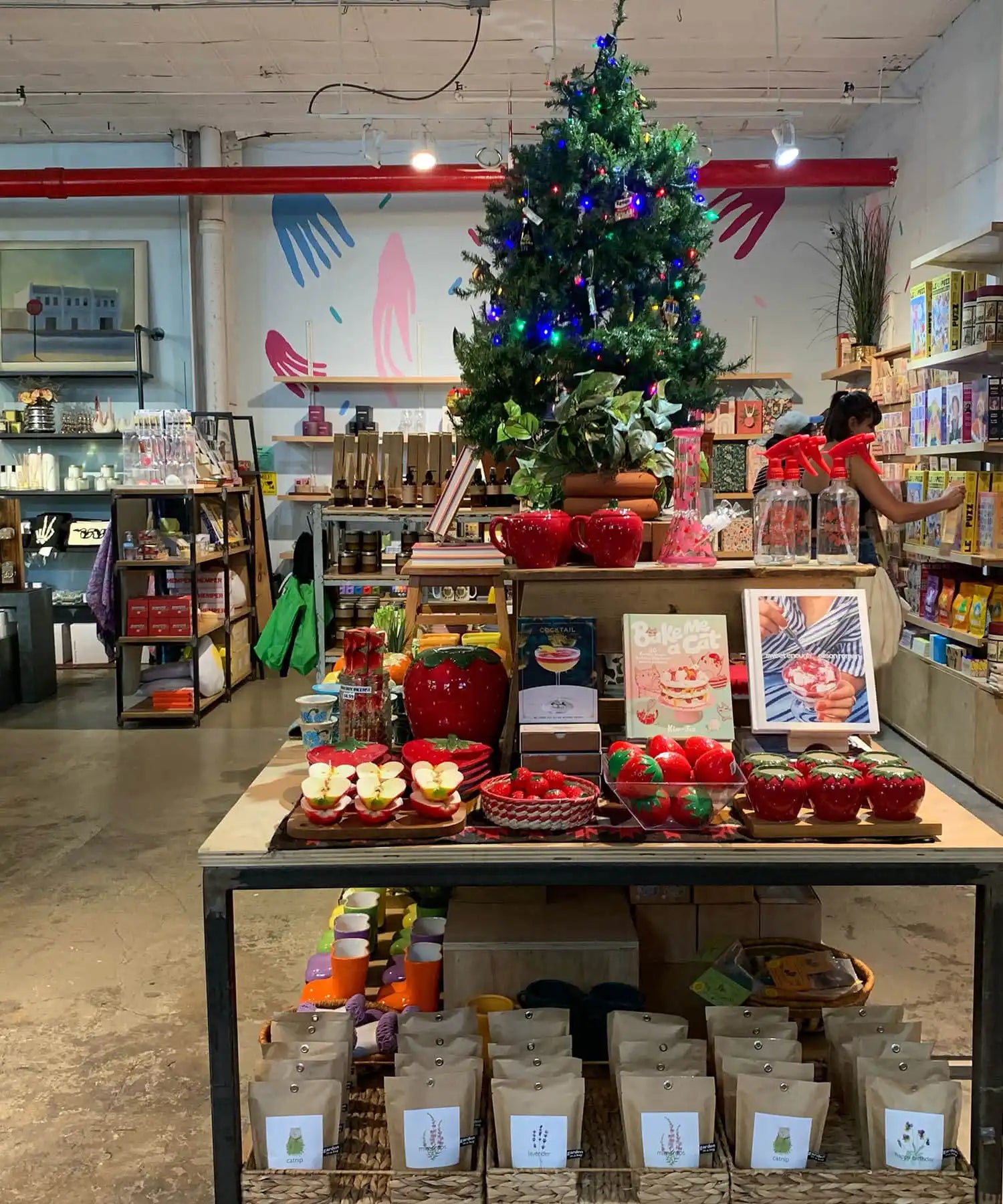 Decorated Christmas tree with blue ornaments stands atop a retail display table.