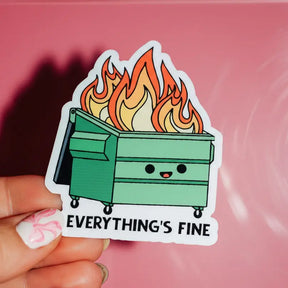 Sticker of a flaming dumpster with 'Everything's Fine' text held against a pink background