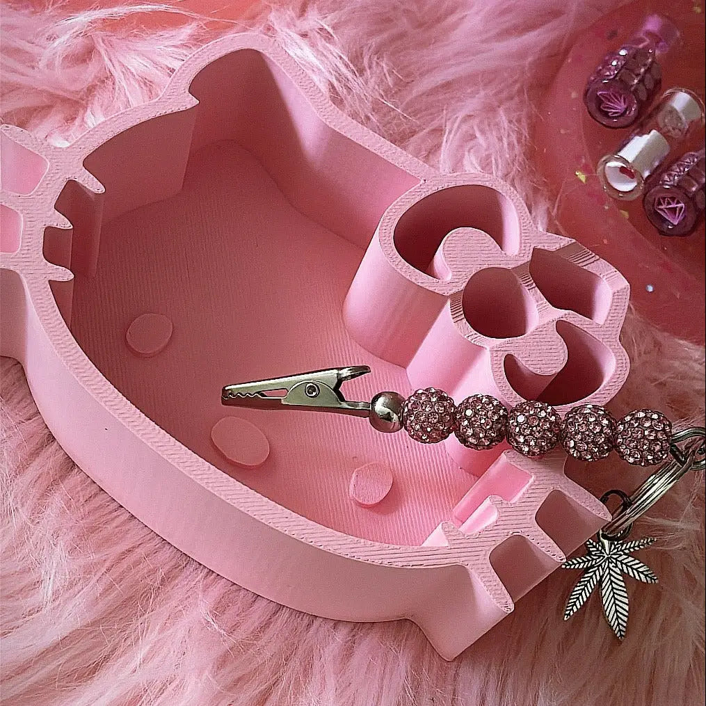 pink ceramic ashtray shaped like hello kitty