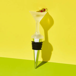Wine bottle stopper with martini-shaped top on a yellow background