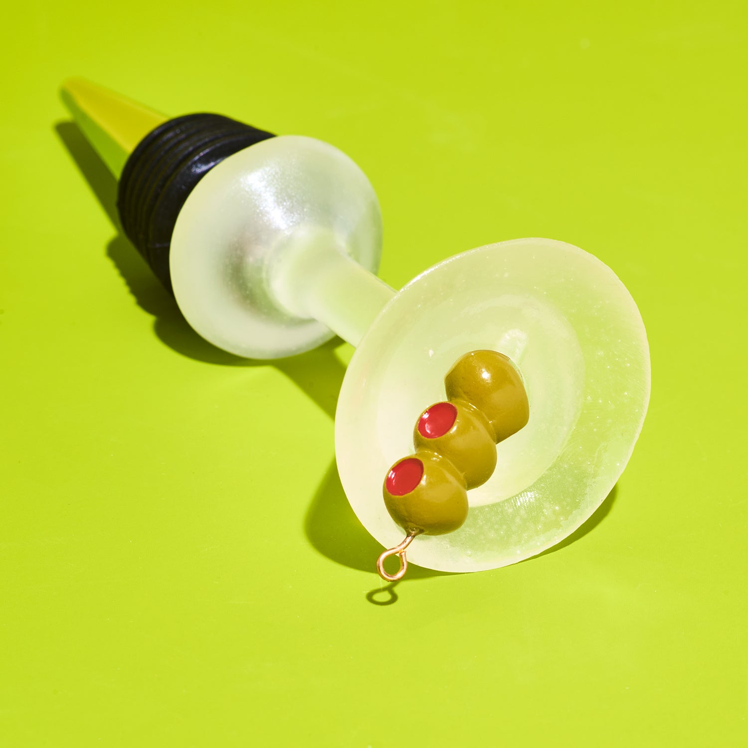 Wine bottle stopper with olives on a green background