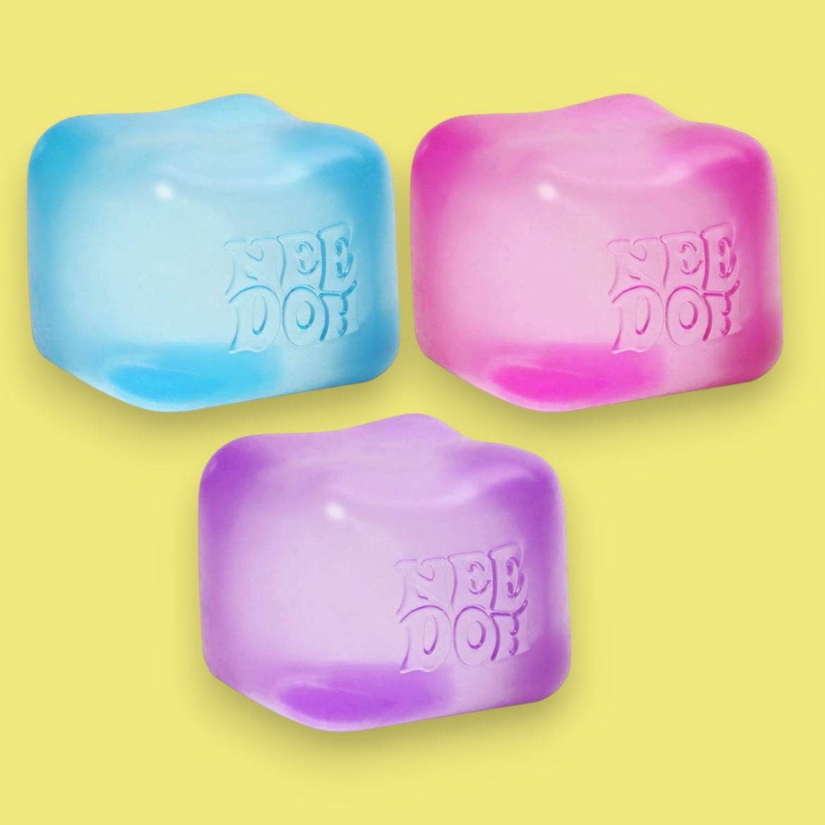 Three colorful ice cube-shaped objects with 'Nee Doh' branding on a yellow background