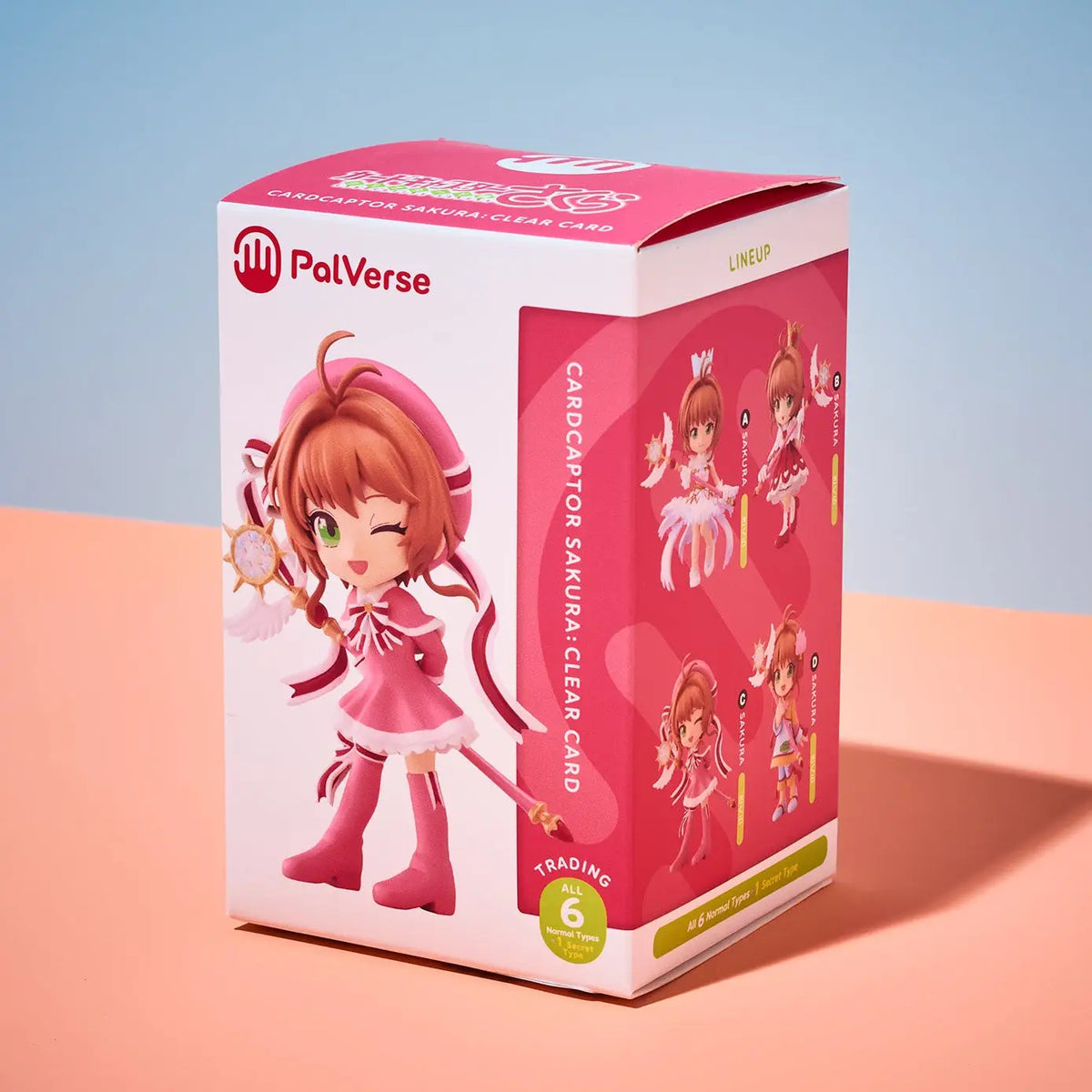 A pink and white PalVerse collectible card box featuring an anime-style character illustration, photographed on a peach and light blue gradient background.