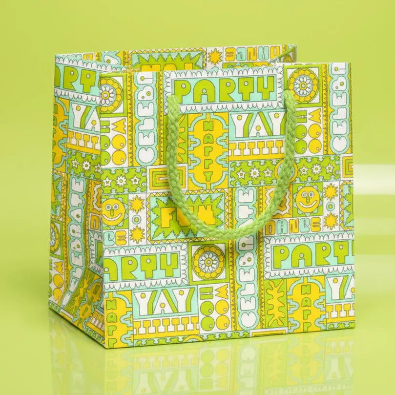 Colorful gift bag with celebratory text and patterns on a light blue background