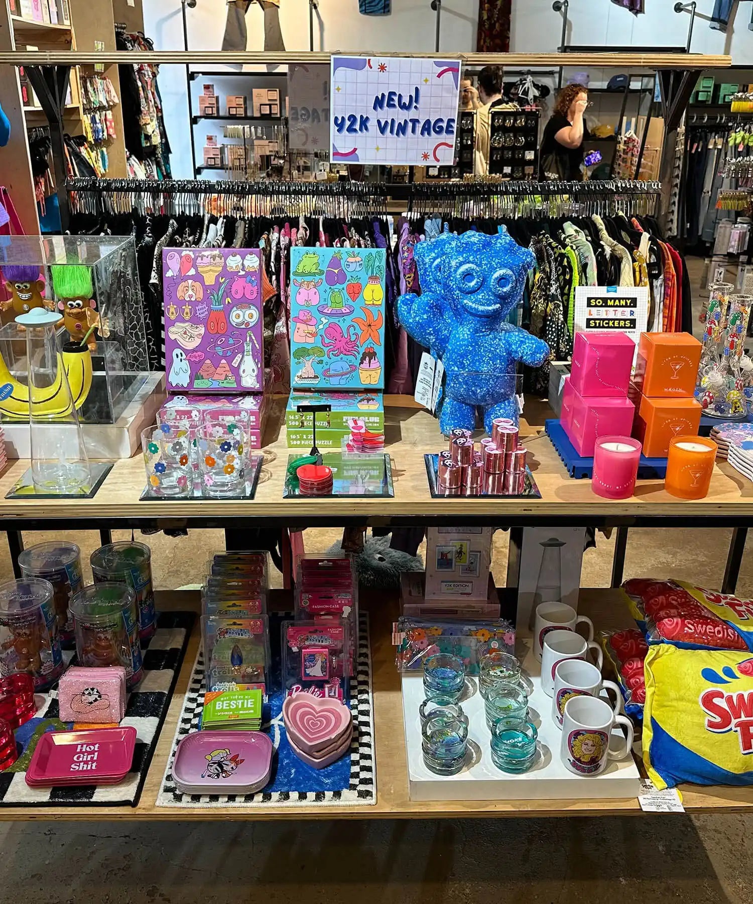 Retail display shelf filled with colorful toys, stationery items, and novelty merchandise.