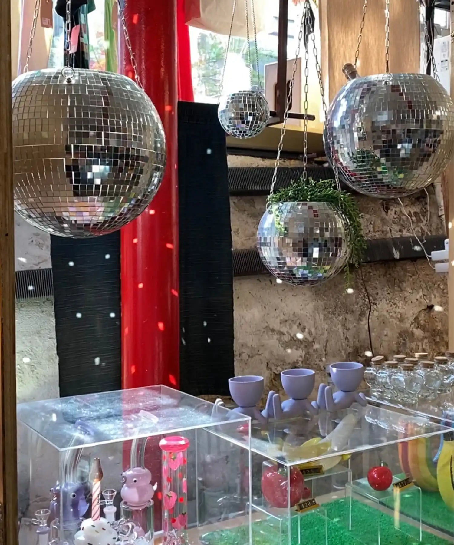 Shiny disco balls hanging from above.