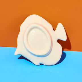 Fish-shaped object on a blue and orange background