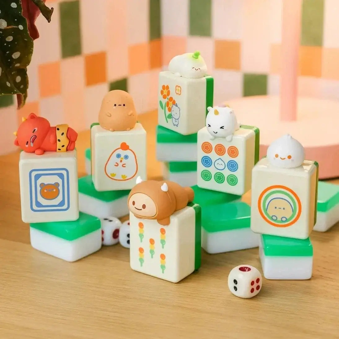 Set of colorful n mahjong tiles with cartoon characters on them on a wooden surface.