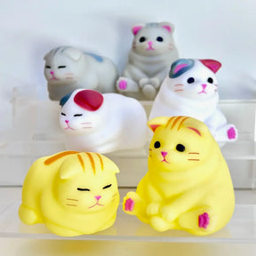 Set of cat-shaped squishies on a white surface