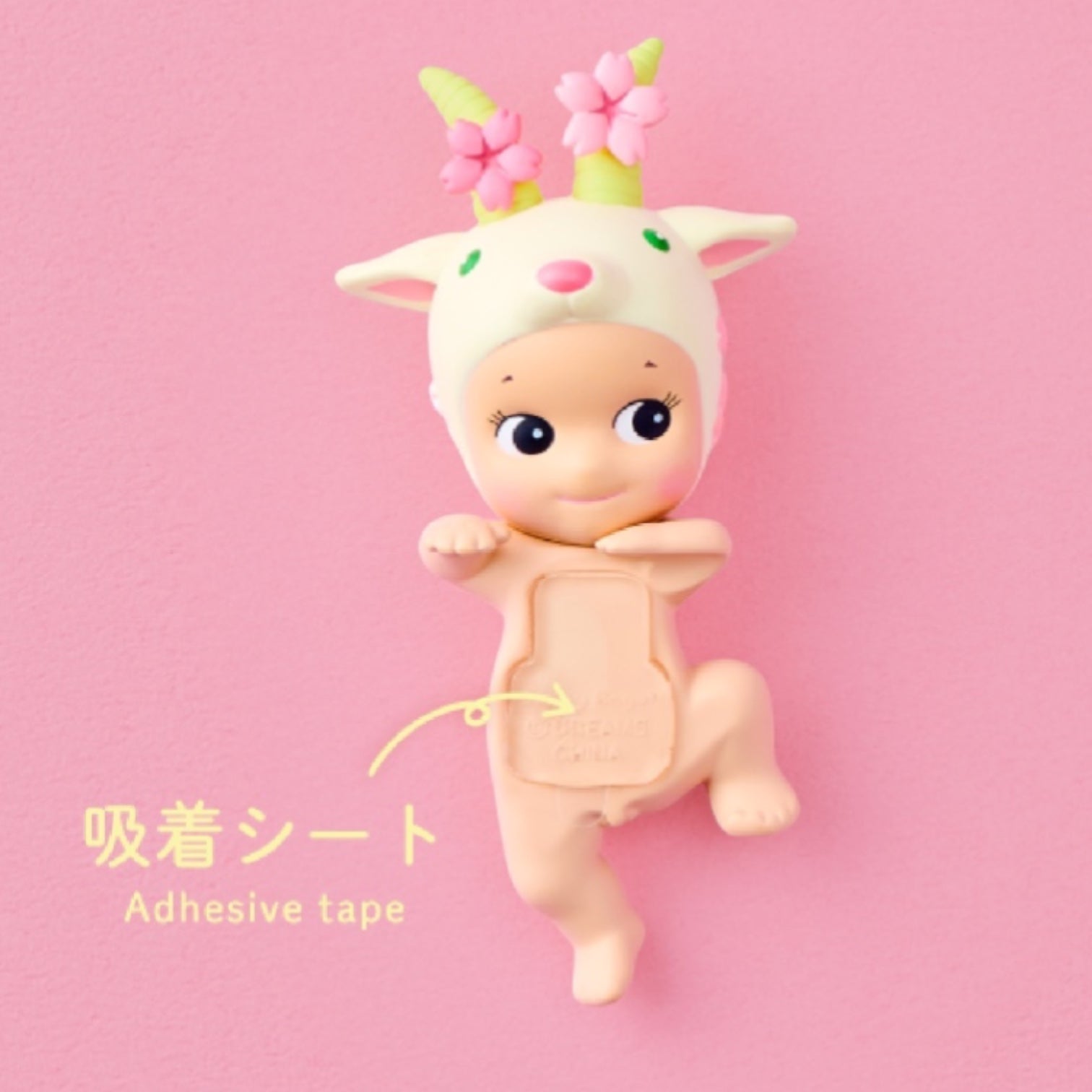 Toy figure with deer-like design on a pink background