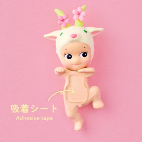 Toy figure with deer-like design on a pink background