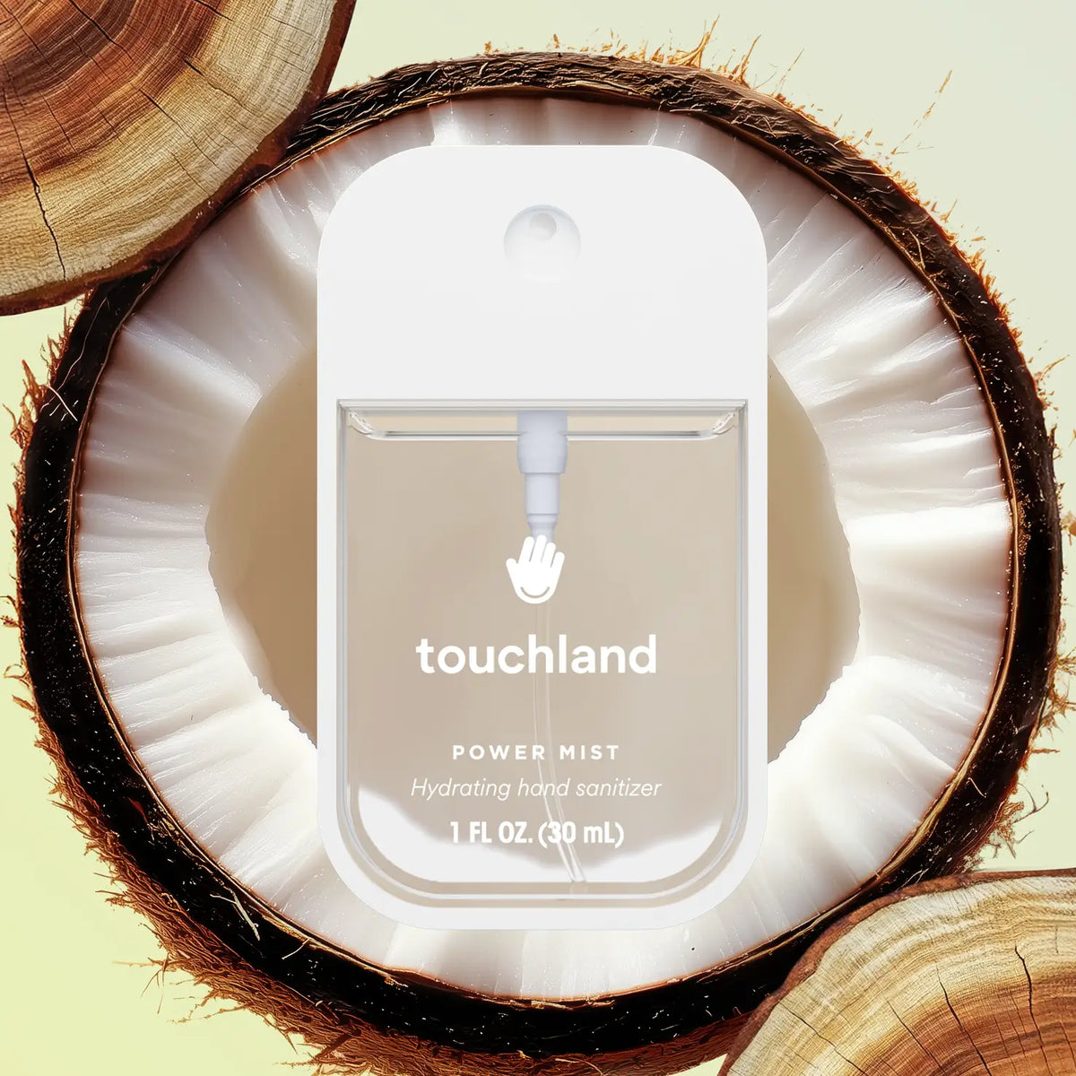 Touchland hand sanitizer bottle inside a coconut shell on a light green background