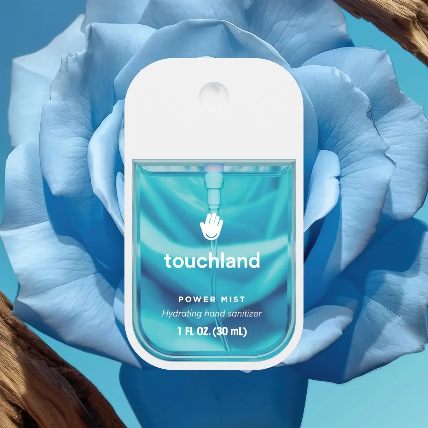 Touchland hand sanitizer bottle with a blue flower in the background