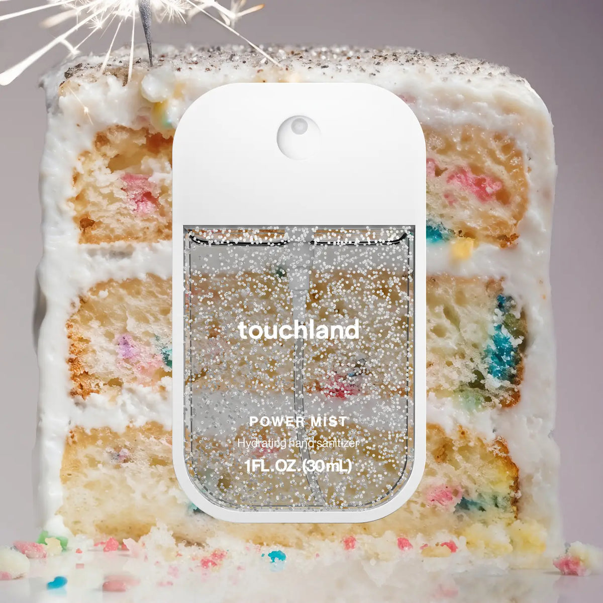 Touchland power mist bottle with a cake background