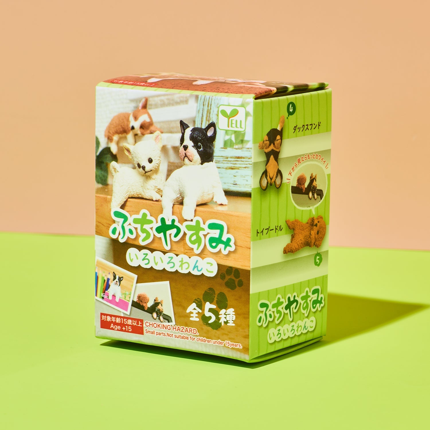 Box of small animal figurines with Japanese text on a colorful background